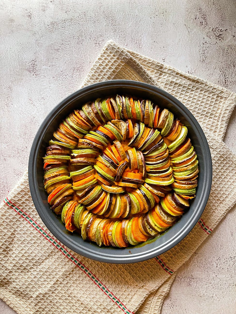 a pan filled with sliced vegetables on a cloth